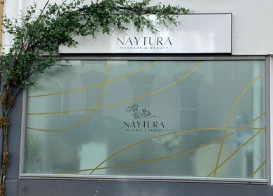 Front view of Naytura Massage and Beauty at Saint Helier, St Helier, JE with green signage.