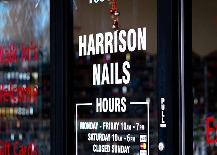 Entrance of Harrison Nails salon in Harrison, Ohio, US showcasing welcoming signage and operating hours.