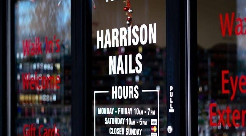 Entrance of Harrison Nails salon in Harrison, Ohio, US showcasing welcoming signage and operating hours.