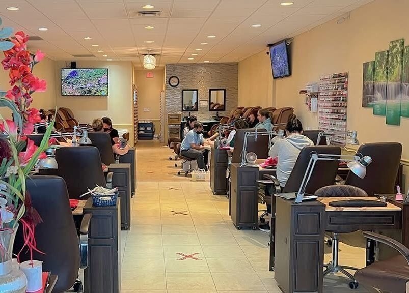 Customers relax at Harrison Nails in Harrison, Ohio, US, enjoying luxurious nail treatments in a serene setting.