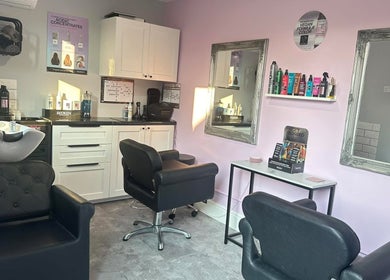 Modern interior of Hair by Emmie in Sudbury, England, GB with stylish chairs and beauty products.
