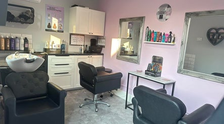 Modern interior of Hair by Emmie in Sudbury, England, GB with stylish chairs and beauty products.
