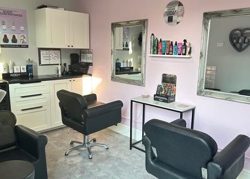 Elegant salon space at Hair by Emmie, Sudbury, England. Modern chairs and mirrors in a cozy setting.