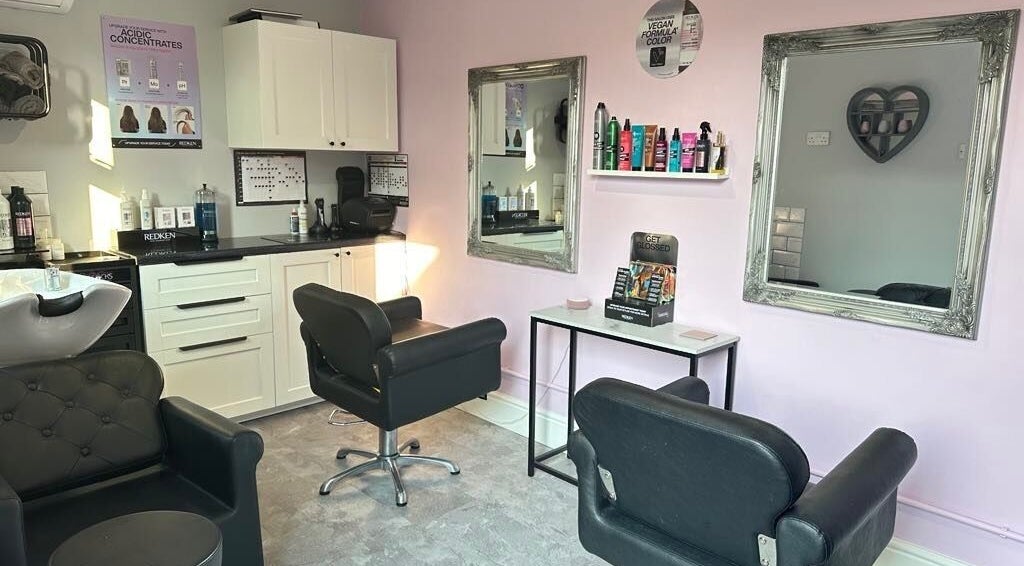 Elegant salon space at Hair by Emmie, Sudbury, England. Modern chairs and mirrors in a cozy setting.
