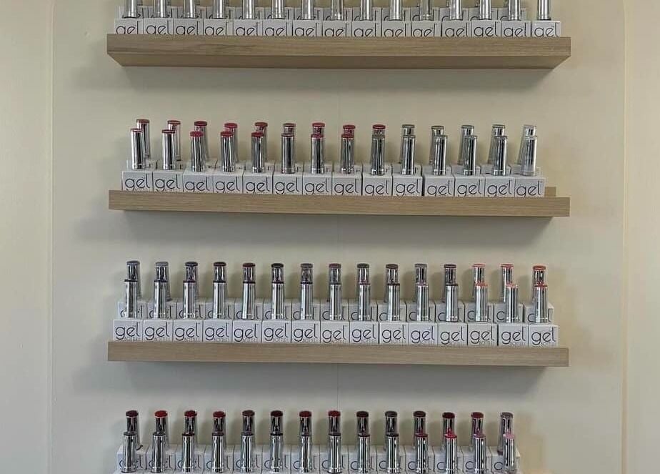 Nail polish gel display at El’Hara Beauty in Prestwick, Scotland. Organized shelves showcasing vibrant colors.