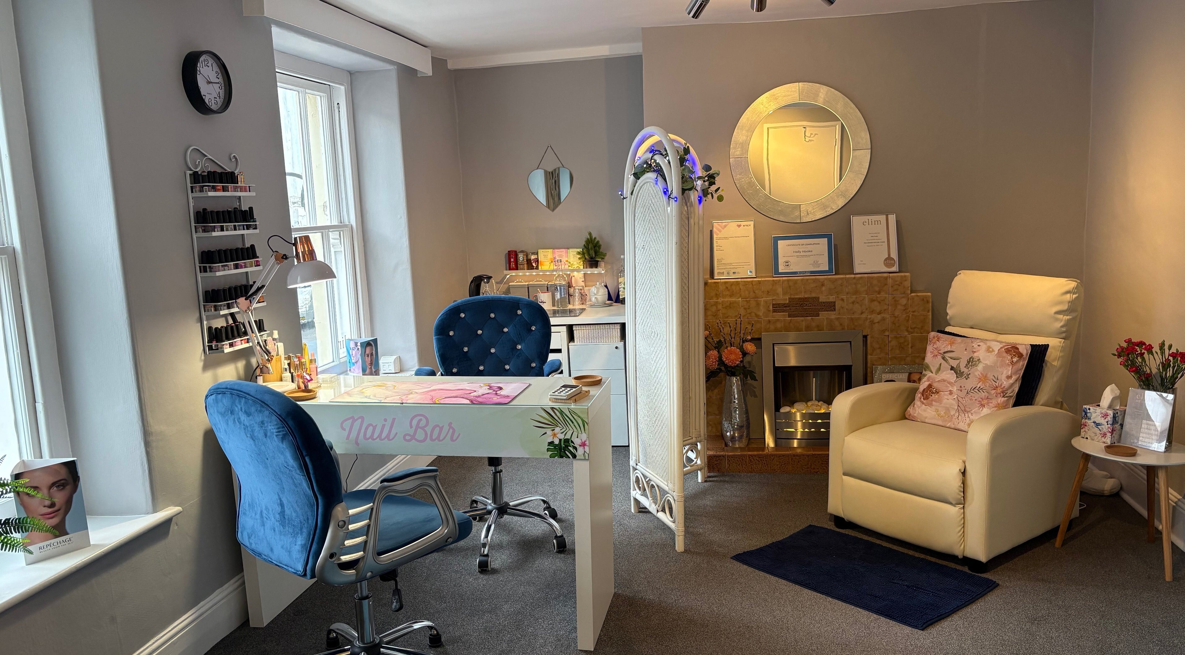 Elegant nail bar and cozy seating at WellSkin Clinic in Wells, England, GB, featuring modern decor.