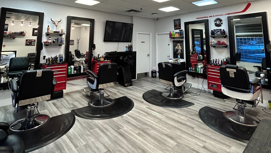 Interior of Brotherhood Barber Shop Millrise in Calgary, Alberta, CA showcasing modern chairs and styling stations.