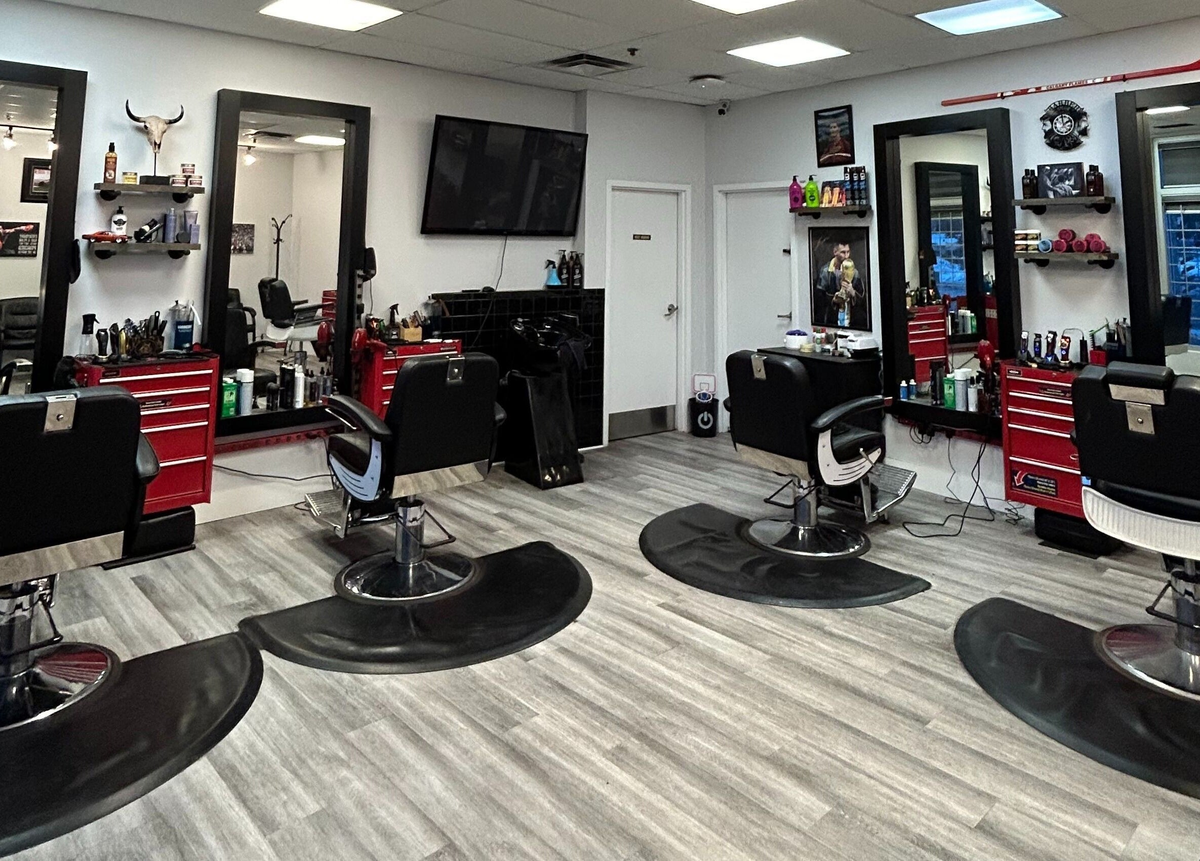 Interior of Brotherhood Barber Shop Millrise in Calgary, Alberta, CA showcasing modern chairs and styling stations.