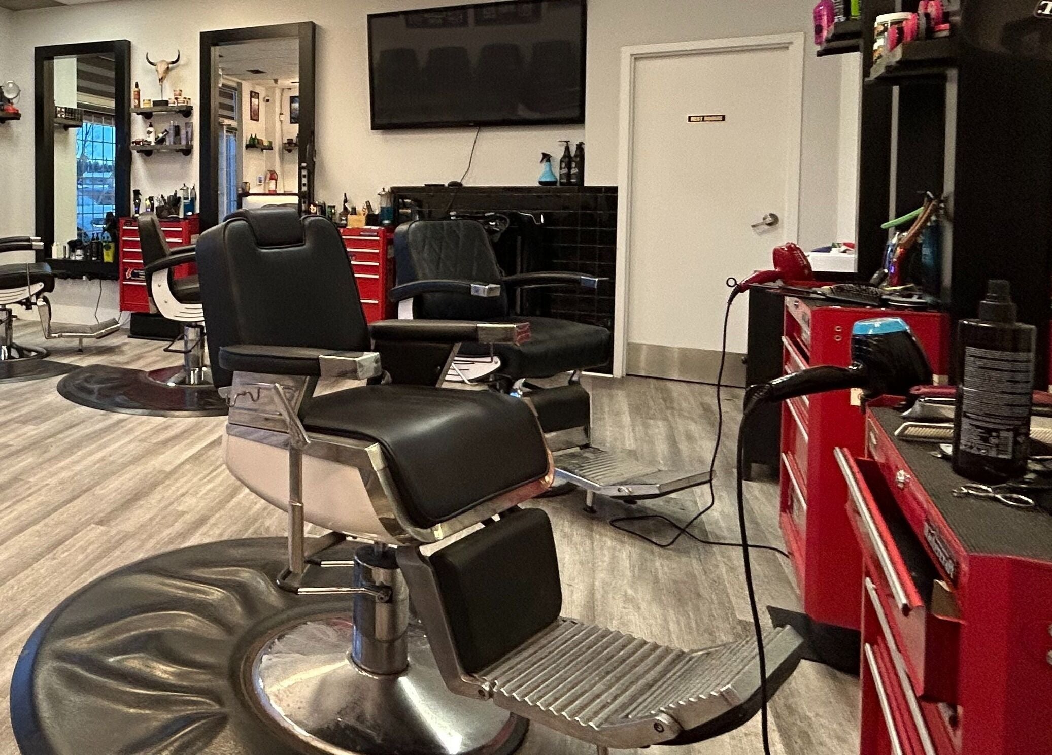 Modern barber chairs at Brotherhood Barber Shop Millrise in Calgary, Alberta, CA with sleek, organized workstations.
