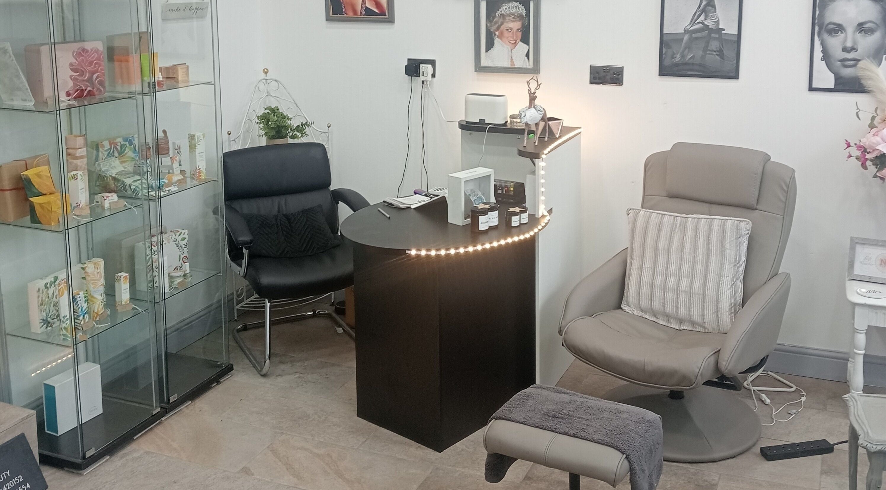 Comfortable seating and display shelf at NV Beauty Macclesfield, Macclesfield, England, GB, creating a serene ambiance.