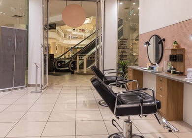 Interior of Grace Threading- Myer Centre in Brisbane City, Queensland, AU showcasing stylish chairs and mirrors.