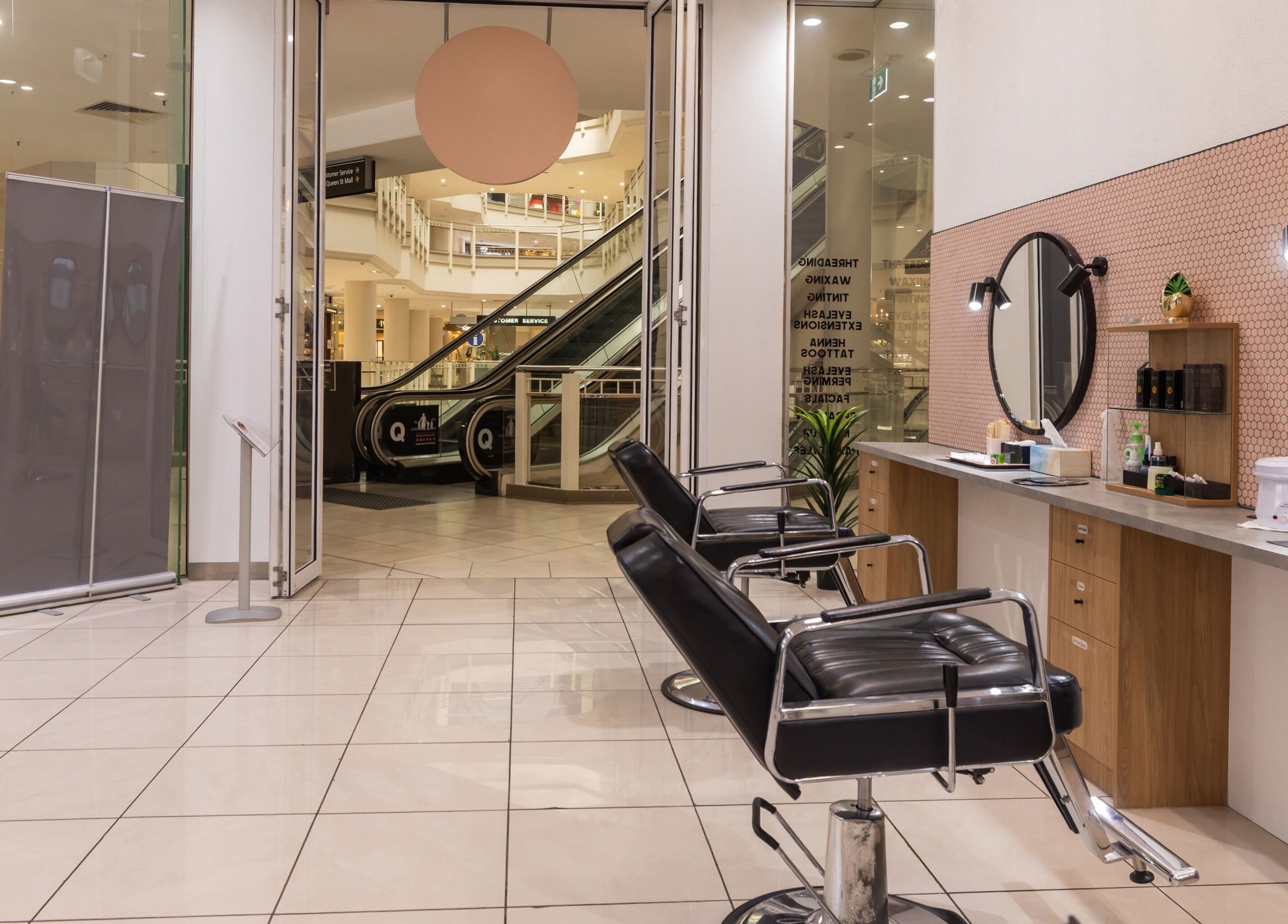 Interior of Grace Threading- Myer Centre in Brisbane City, Queensland, AU showcasing stylish chairs and mirrors.