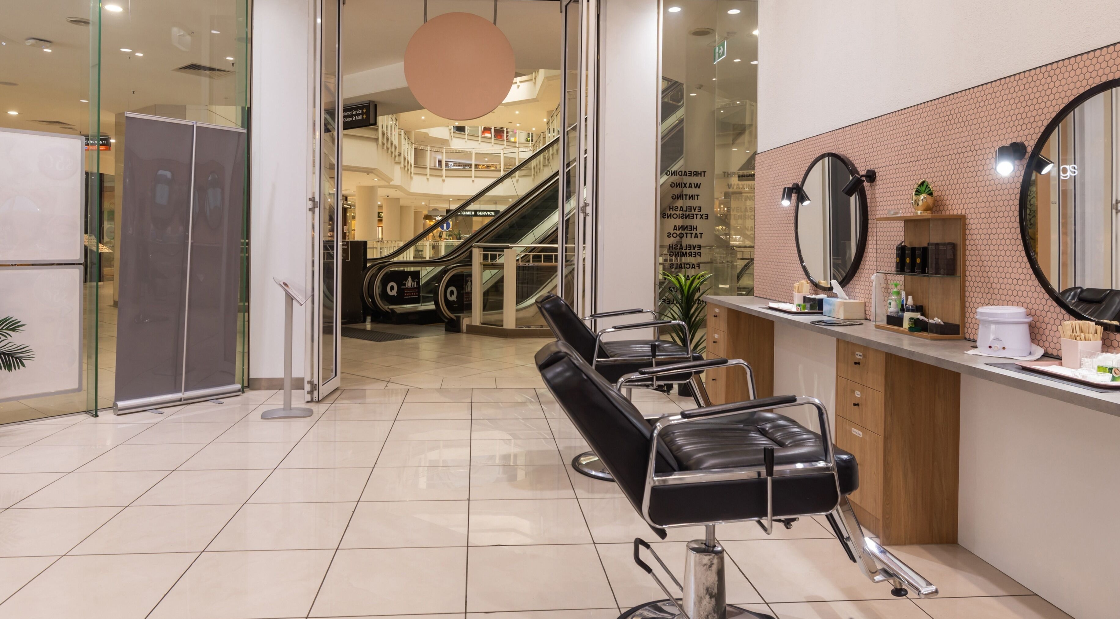 Interior of Grace Threading- Myer Centre in Brisbane City, Queensland, AU showcasing stylish chairs and mirrors.