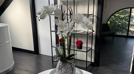 Elegant white orchids adorn the serene interior of Dr Sam Rigby Facial Aesthetics in Cockermouth, England, GB.