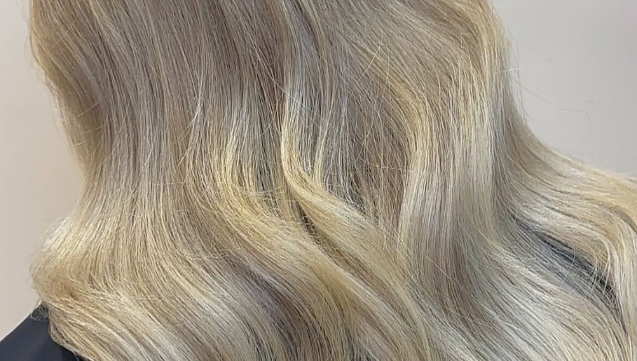 Blonde hair styled in waves at Eden Hair at David Lloyd Long Ashton, Bristol, England, GB.