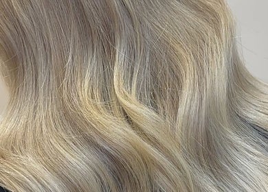 Blonde hair styled in waves at Eden Hair at David Lloyd Long Ashton, Bristol, England, GB.