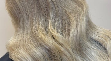 Blonde hair styled in waves at Eden Hair at David Lloyd Long Ashton, Bristol, England, GB.