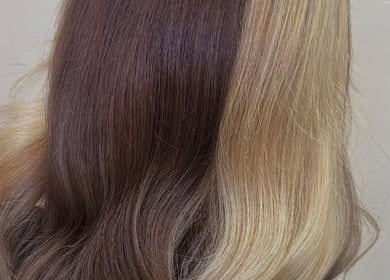 Elegant brunette and blonde balayage at Eden Hair, Bristol, England, GB, showcasing smooth, wavy hair.