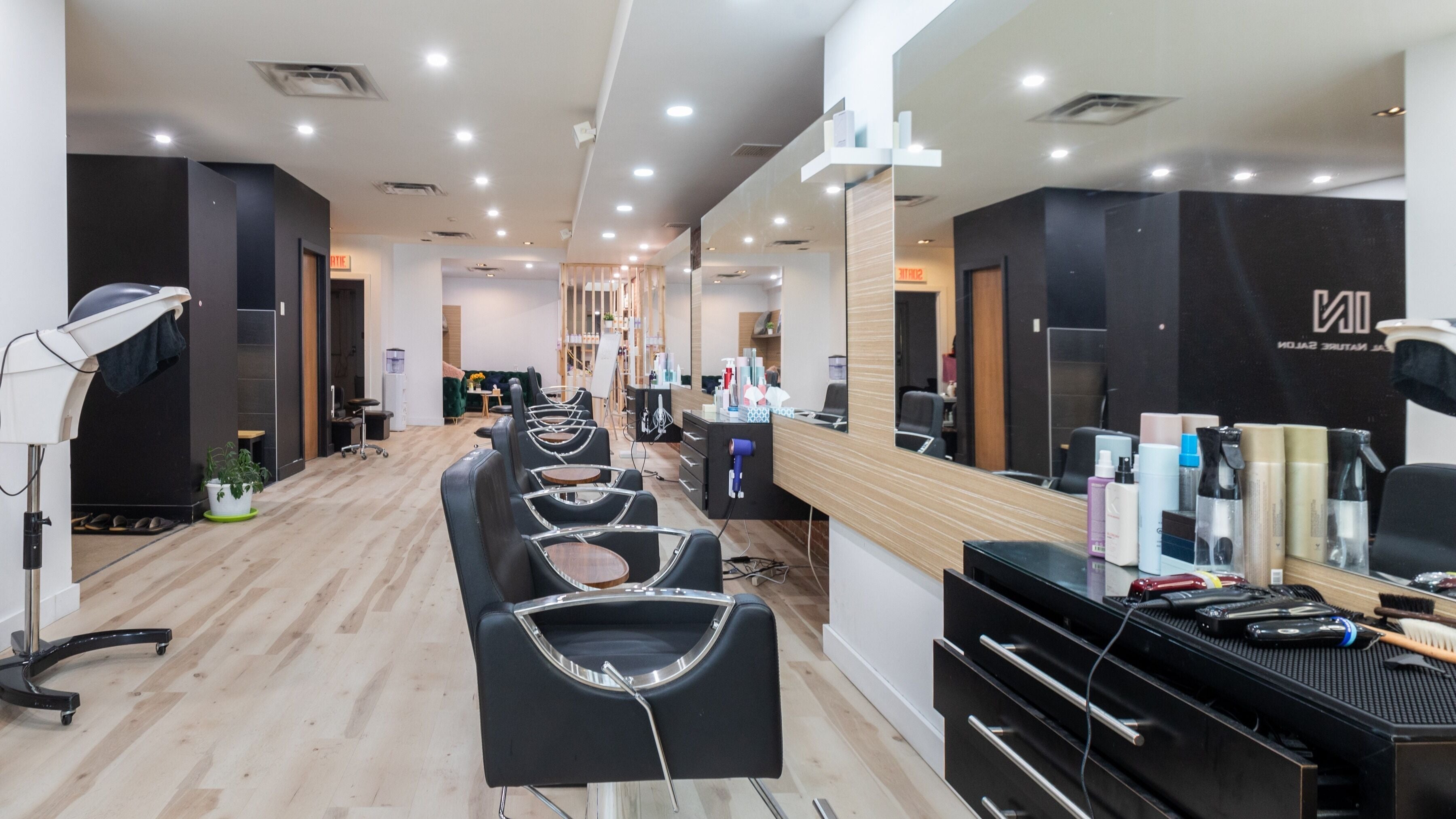 Stylish salon interior at IN Salon - Galerie & Riria, Montréal, Québec, CA, showcasing modern design.
