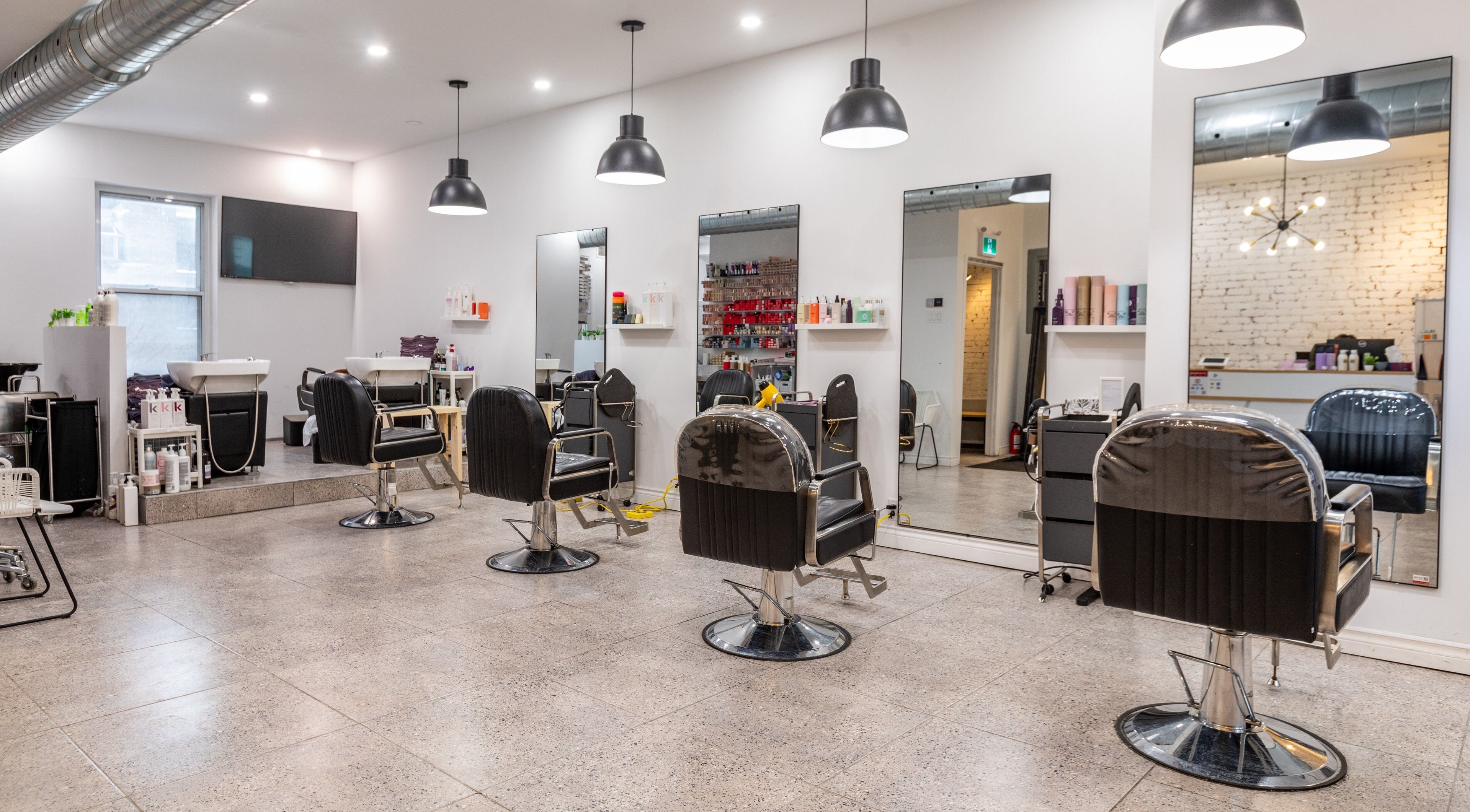 Modern interior of IN Salon-Saint-Mathieu with stylish salon chairs and mirrors in Montréal, Québec, CA.