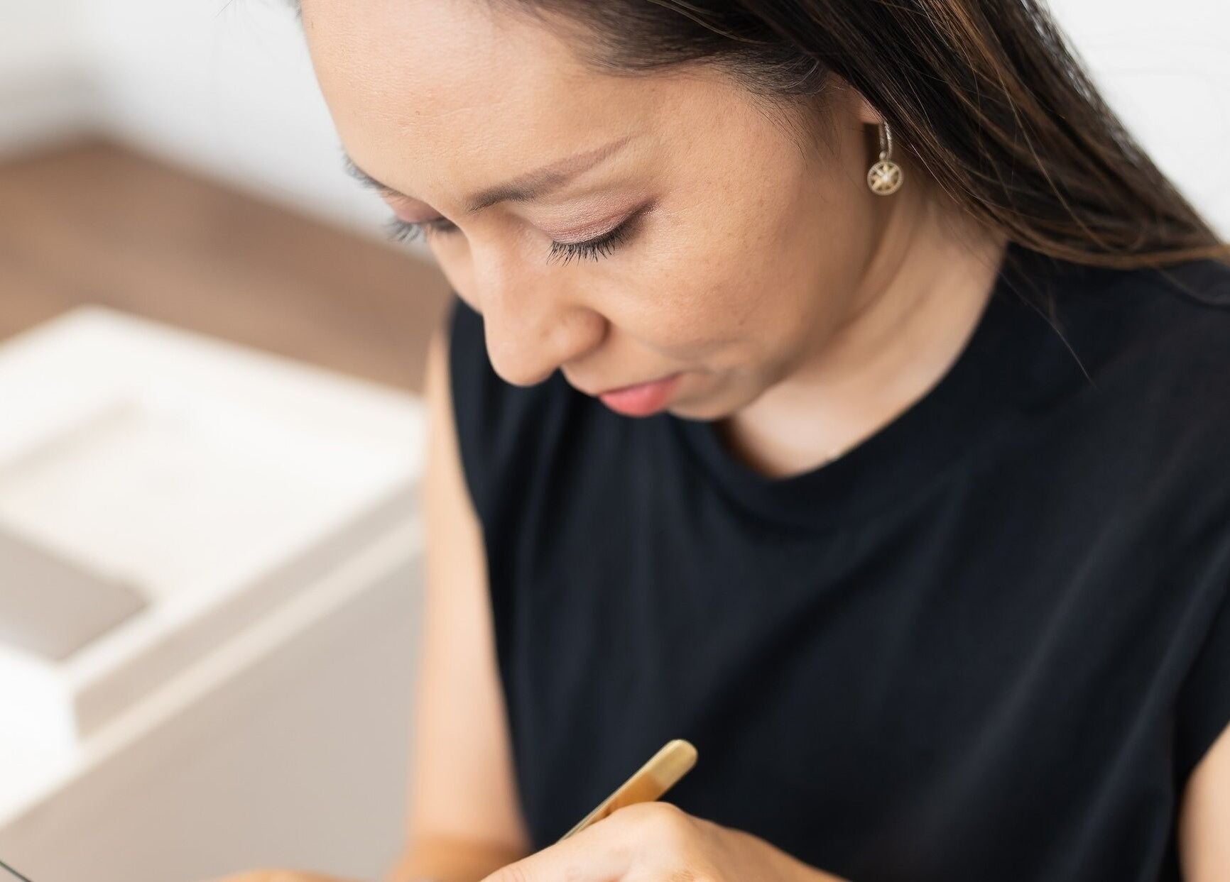 Expert lash artist at Theory Lash & Brow in Buddina, QLD, focused on precision application.