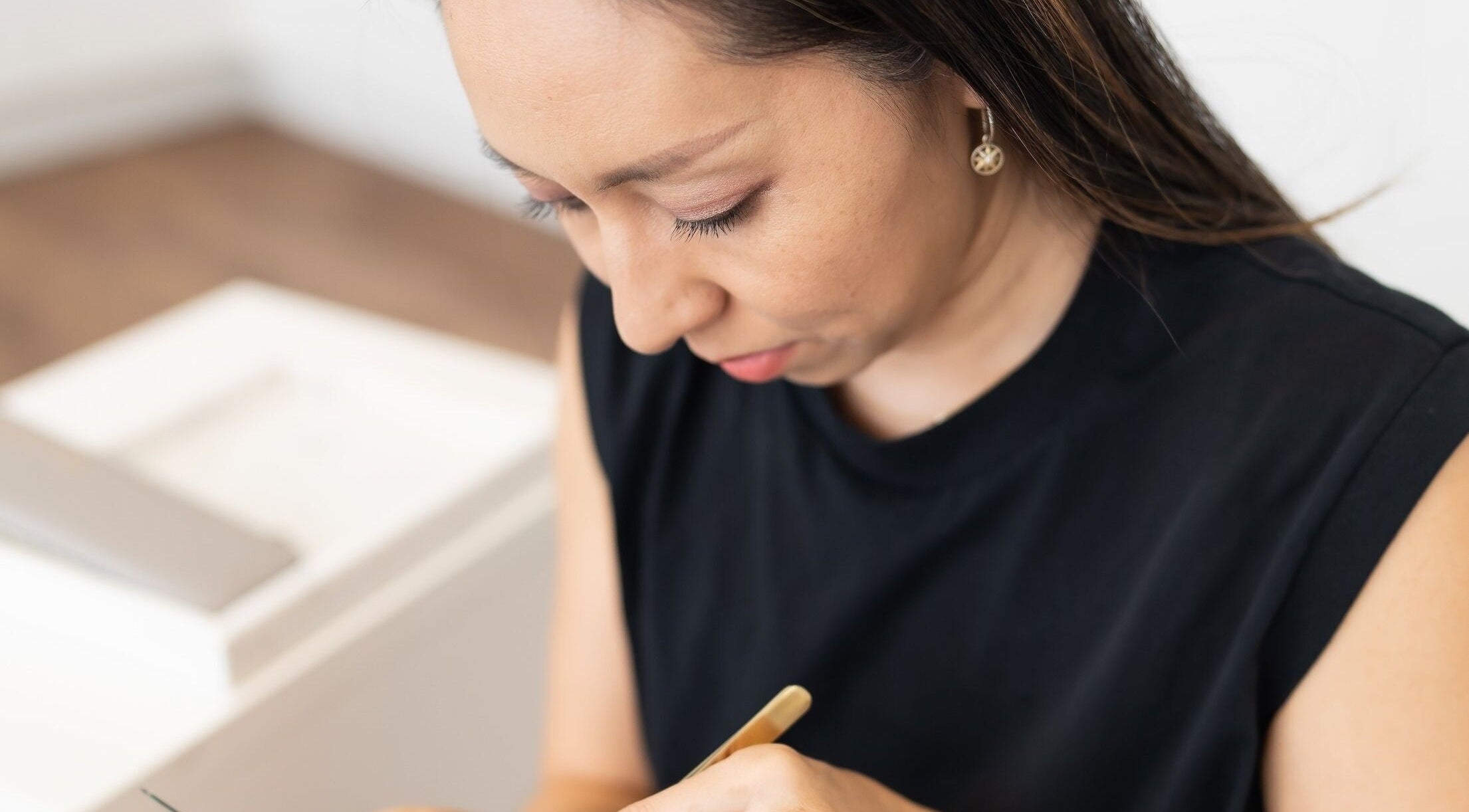 Expert lash artist at Theory Lash & Brow in Buddina, QLD, focused on precision application.