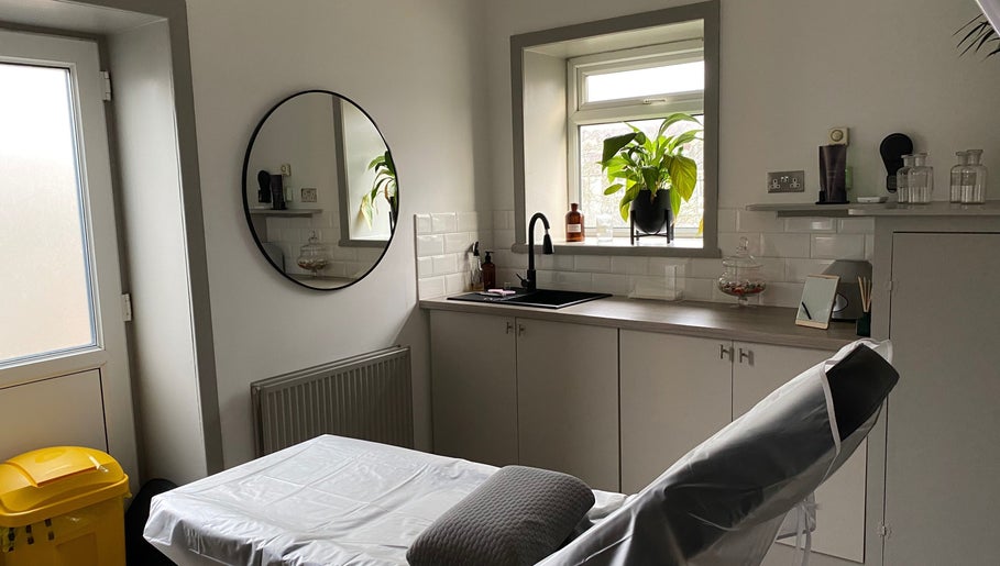 Tranquil treatment room at Fitzys Hair and Beauty, Accrington, England, GB, featuring a mirror and greenery.