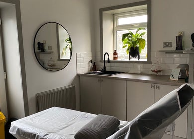 Tranquil treatment room at Fitzys Hair and Beauty, Accrington, England, GB, featuring a mirror and greenery.