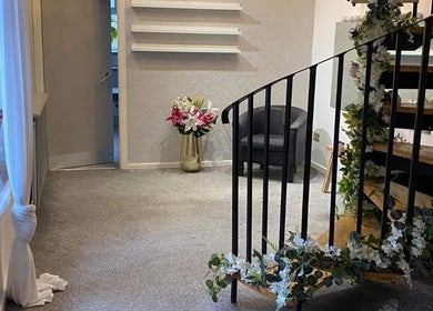 Elegant spiral staircase with floral decor at Fitzys Hair and Beauty, Accrington, England, GB.