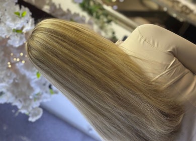 Blonde hair styled at Fitzys Hair and Beauty in Accrington, England, GB. Chic salon backdrop enhances elegance.