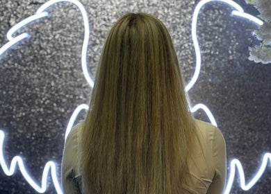 Luxurious hair transformation at Fitzys Hair and Beauty, Accrington, England, GB, with glowing angel wings backdrop.