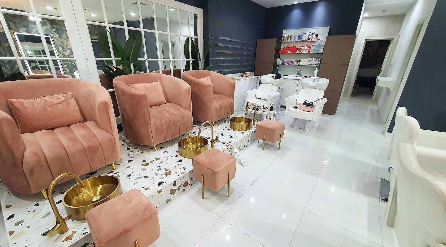 Elegant seating area at Las Meninas Salon - Dubailand, Dubai, Dubai, AE showcasing plush chairs and foot baths.