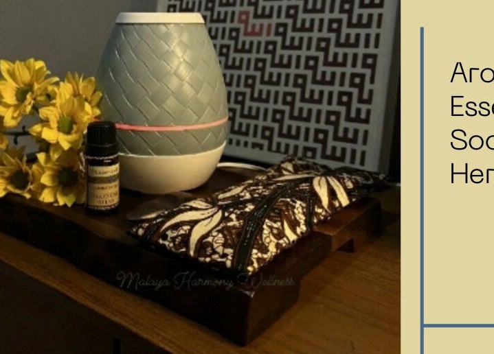 Aromatherapy setup at Malaya Harmony Wellness in Kuala Lumpur, featuring essential oils and yellow flowers.