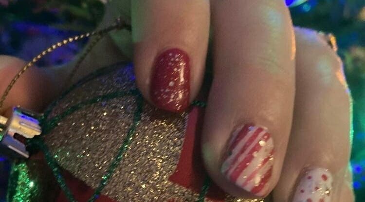 Festive glittery red and white nail art by Mud Beauty in Hook, England, GB.