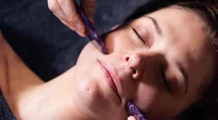Woman enjoying facial massage at Mud Beauty, Hook, England, GB, enhancing relaxation and skin rejuvenation.
