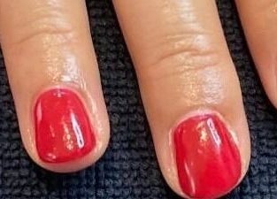 Elegant red manicure at Mud Beauty, Hook, England, GB offering premium nail services.