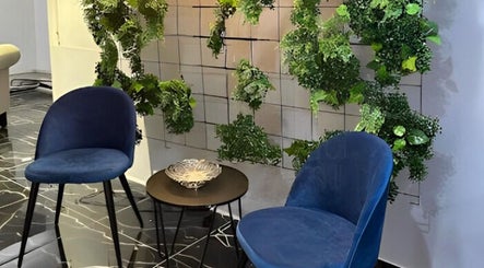 Chic seating with greenery at Enrich - Brazilian Beauty Collective, Rockdale, New South Wales, AU.
