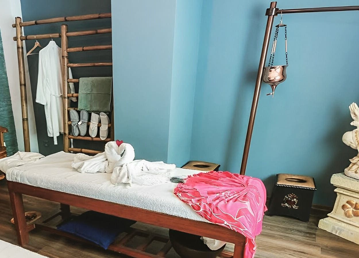 Relaxing spa room at Bali Temple Spa, București, with a massage bed and serene decor.