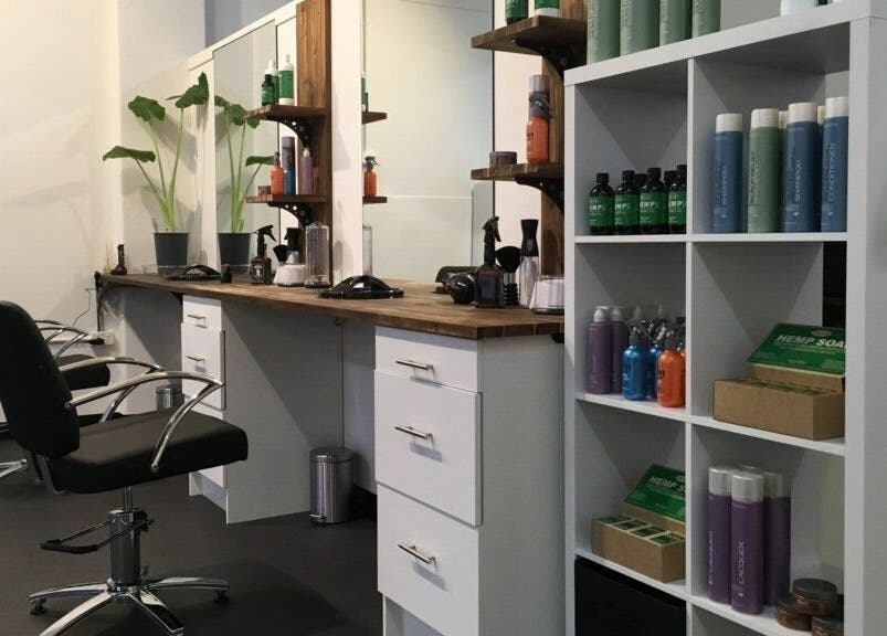 Modern salon setup at Cutting Crew Australia, Taree, New South Wales, AU, showcasing chairs and products.