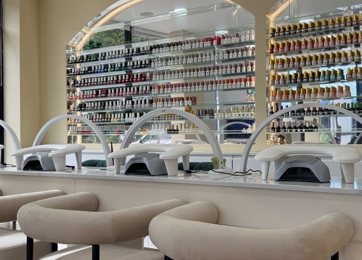 Elegant nail station at Nu Haven, London, England, GB, showcasing vibrant polish collection and modern design.