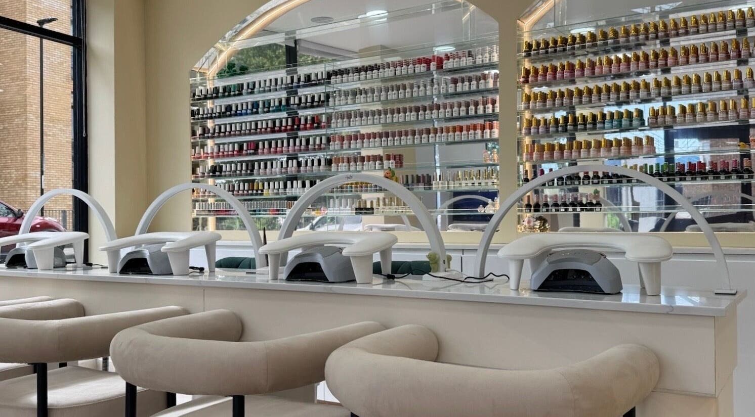 Elegant nail station at Nu Haven, London, England, GB, showcasing vibrant polish collection and modern design.