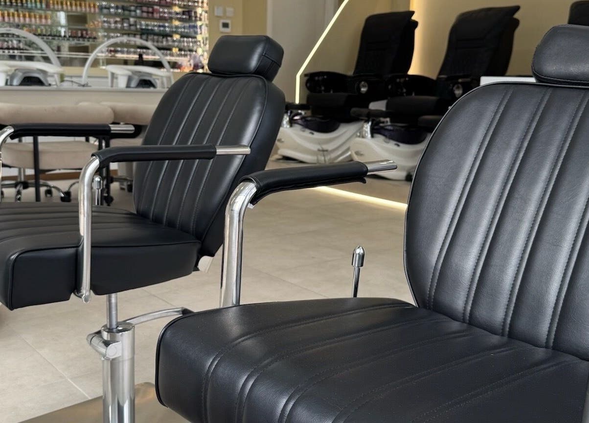 Elegant black salon chairs at Nu Haven, London, England, GB, showcasing modern beauty and wellness comfort.