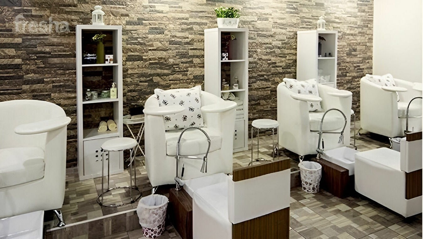 Relaxing pedicure area at Stella Beauty Salon, Dubai, Dubai, AE with plush seating and modern decor.