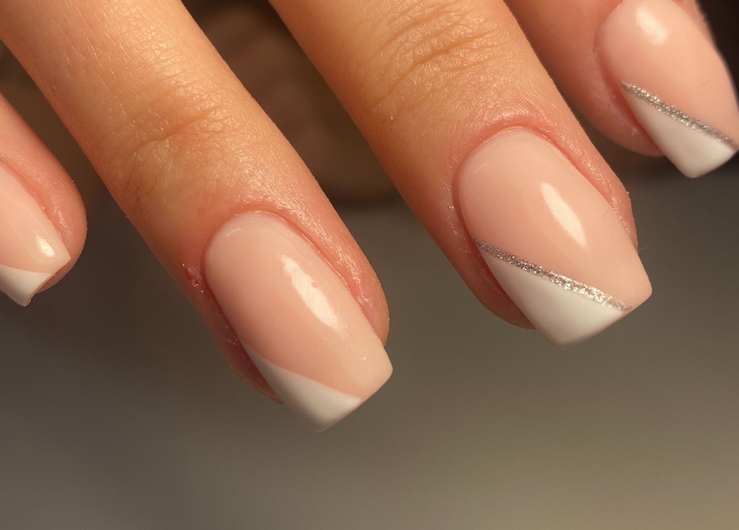 Elegant French manicure with silver accents at Gina Rose Beauty, Sutton Coldfield, England, GB.