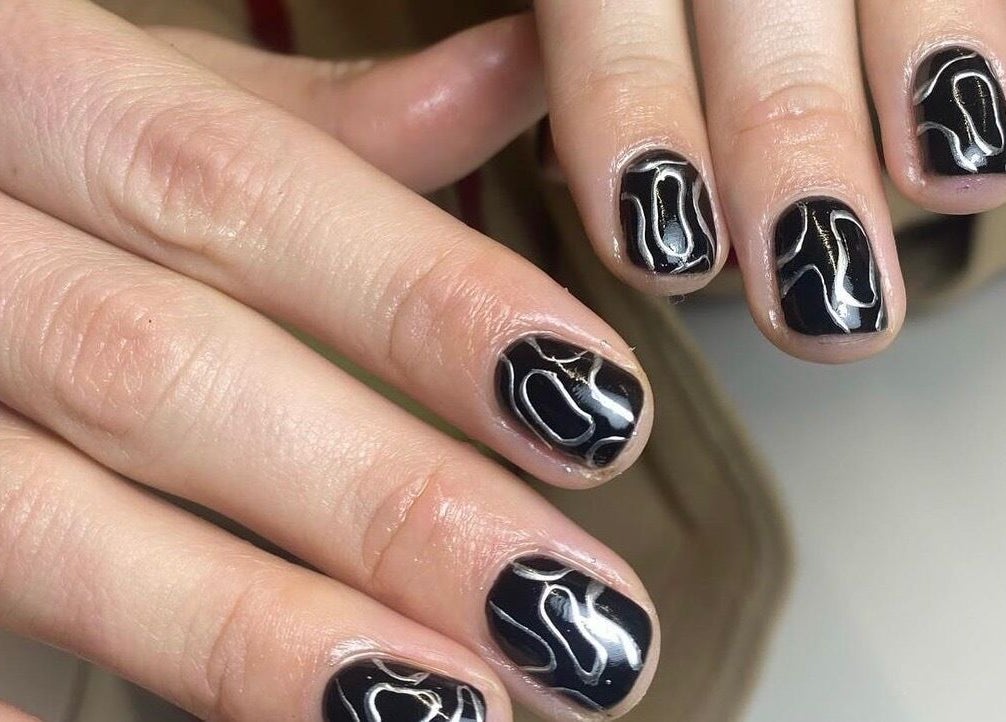 Stylish nail art in black and white lines at Gina Rose Beauty, Sutton Coldfield, England, GB.