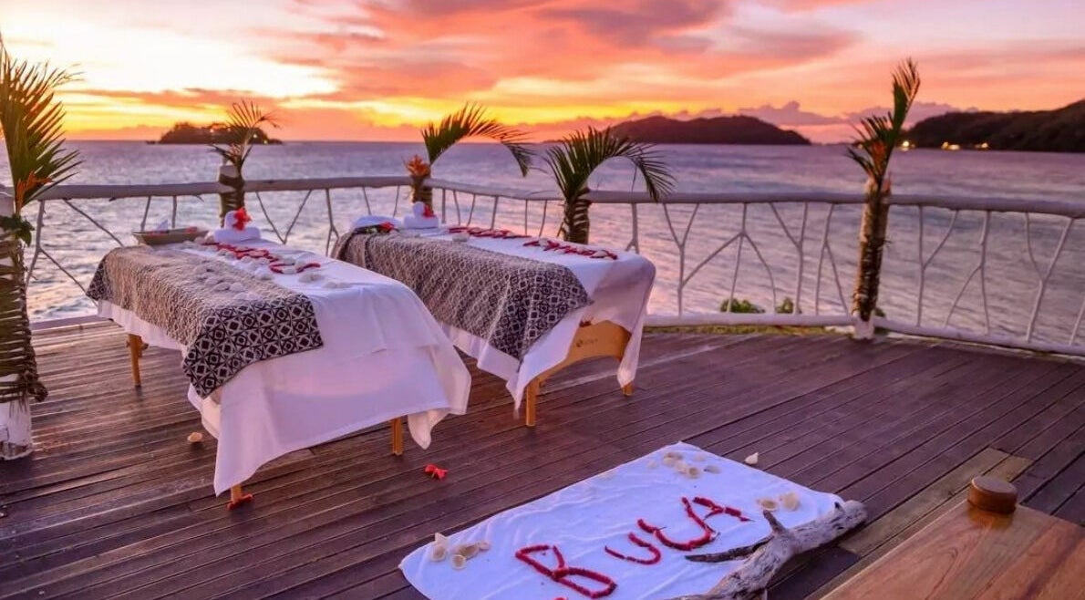 Outdoor massage tables at sunset overlooking the ocean at Tropica Spa, Malolo Levu, Western Division, FJ.