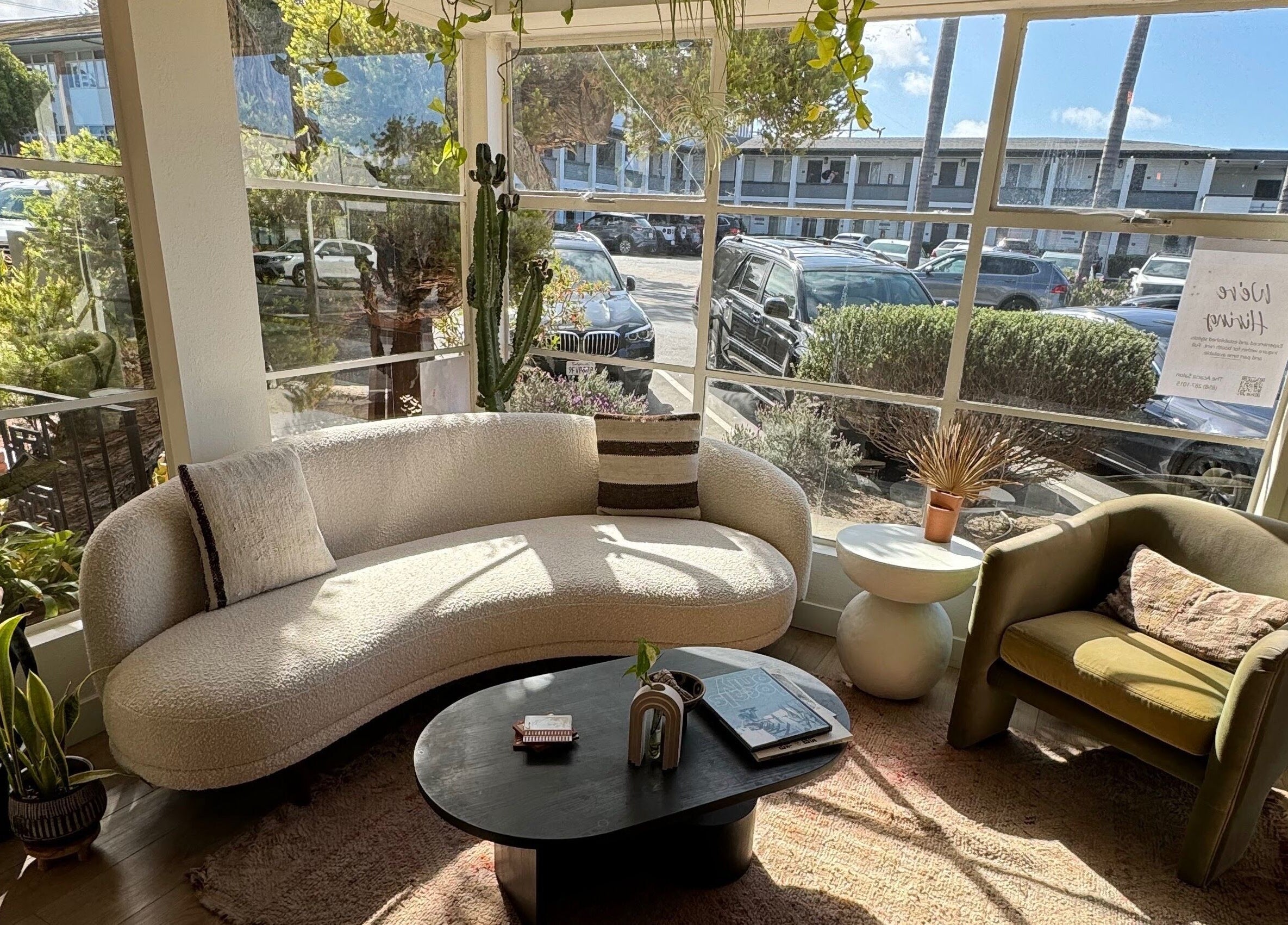 Cozy seating area at The Acacia Salon, San Diego, California, US with natural light and plants.