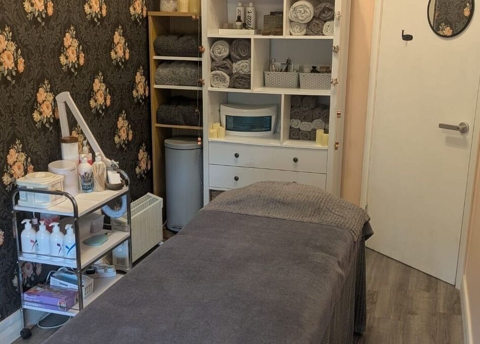 Relaxing treatment room at The Beauty Box, Battle, England, GB, featuring floral decor and plush furnishings.