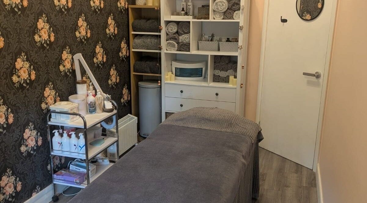 Relaxing treatment room at The Beauty Box, Battle, England, GB, featuring floral decor and plush furnishings.