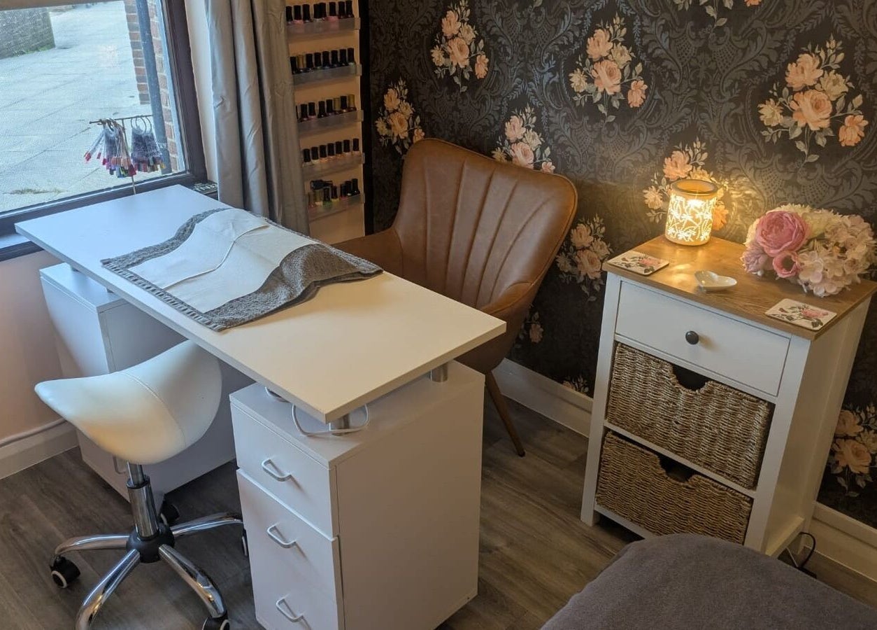 Elegant nail salon setup at The Beauty Box, Battle, England, GB, showcasing a cozy chair and floral decor.